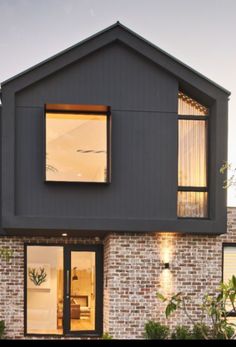 a modern house with an open window and brick facade is featured in this image from the outside