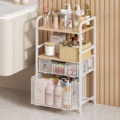 a bathroom shelving unit with baskets on the bottom shelf and toiletries in it