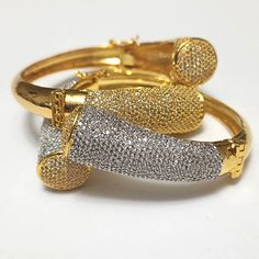 "These goregous bracelet has brilliant simulated pave set stones that sparkle brightly in any light. It's perfect for the any time you want to feel special. Made of High Quality CZs. The plating has a gold content of approx 5 to 15 milligrams complete with rhodium plating that makes this bracelet set to last!  fits up to 7.25\" wrist." Glamorous Sparkling Diamond Bracelet, Party Bracelet With Pave Setting, Glamorous Sparkling Bangle Bracelets, Glamorous Sparkling Bangle Bracelet, Diamond White Cubic Zirconia Bangle With Pave Setting, Dazzling Bracelets With Pave Setting In Cubic Zirconia, Dazzling Bangle Bracelet With Sparkling Stones, Gold Bracelets With Pave Setting For Wedding, Sparkling Diamond Bangle Crystal Bracelet