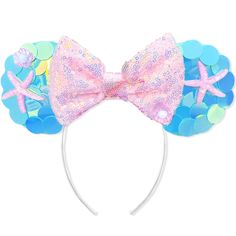 a pink and blue minnie mouse ears headband with starfish, seashells and shells on it