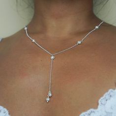 If you want to add a touch of glamour to any outfit, this Sofia necklace is sure to turn heads. This beautiful piece features an eye-catching Y shape design adorned with seven small freshwater pearls on a sophisticated chain. Team it up with a plunging neckline dress or a low-cut top, the Sofia pearl necklace is sure to make a statement. - Free UK delivery on all orders - Handmade in England, UK - A-grade freshwater pearls carefully selected for their organic and natural shapes - Features seven Elegant Silver Lariat Necklace As Gift, Elegant Sterling Silver Lariat Backdrop Necklace, Elegant Sterling Silver Backdrop Lariat Necklace, Drop Necklaces, Wedding Sterling Silver Pearl Drop Necklace, Elegant Silver Long Drop Backdrop Necklace, Adjustable Backdrop Necklace With Pearl Drop For Gifts, Wedding Sterling Silver Backdrop Necklace, Elegant Pearl Charm Dangle Lariat Necklace