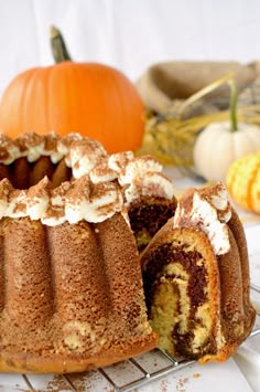 a bundt cake on a cooling rack with pumpkins in the background