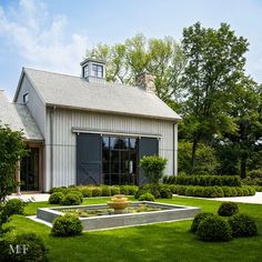 a house with a garden in front of it and trees around the back yard area