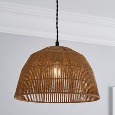 a light fixture hanging from the ceiling in a room with white walls and wood flooring