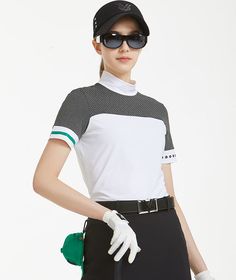 a woman in black and white outfit with sunglasses on her head, holding a green glove