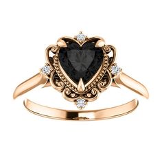 a heart shaped black diamond ring with diamonds