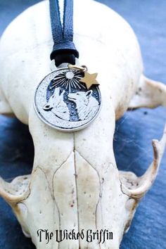 an animal skull with a medallion on it's back and the words, the wicks griffin