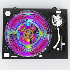 a turntable that is sitting on top of some kind of black surface with colorful designs