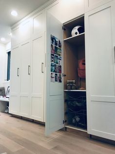 an open closet with pictures on the wall