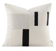 a black and white pillow with stripes on it's side, in front of a white background