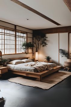 a bed room with a neatly made bed next to two lamps and a plant on the wall