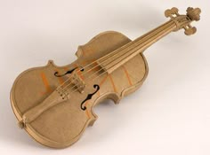 an old violin that is sitting on the ground with its strings still attached to it