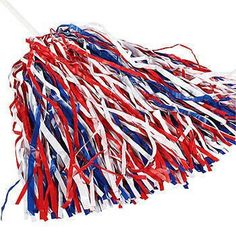 a red, white and blue pom - pom on a stick with streamers