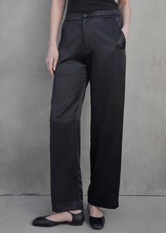 Made from luxurious 100% silk, these wide leg pants provide a comfortable fit. The button zipper closure and elastic waist make them effortlessly wearable, while the slash pockets add a touch of functional style. Perfectly pairs with our Velvet Calabasas Top! Available in Black 100% Silk Dry Clean Shop more women's designer pants here. ABOUT VELVET BY GRAHAM & SPENCER It began in 1997 as an aspiration to create fashion forward tee shirts that embodied the laid-back luxe of LA style. Today it has Womens Pants Design, Fall Outerwear, Functional Style, Designer Pants, Cami Shirt, Beautiful Color Combinations, Luxury Collection, Silk Pants, Silk Charmeuse