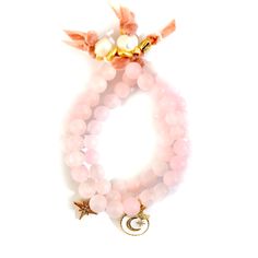 Handcrafted bracelets, AAA grade Rose quartz gemstone bracelets with pavé crystal charms finished with french silk velvet ribbon and freshwater pearls gold plated pebbled tiny rings. The blushing hue of Rose Quartz seems to snag everyone’s heartstrings. There is something about this soft and feminine crystal that oozes pure love. It comes as no surprise that the Rose Quartz meaning is that of universal love. Here is a crystal so ripe with healing properties, so drenched in harmony, and so tender Elegant Pink Hand Wrapped Jewelry, Elegant Rose Quartz Gemstone Beaded Bracelet, Elegant Rose Quartz Gemstone Beaded Bracelets, Elegant Pink Jewelry Hand Wrapped, Elegant Hand Wrapped Pink Jewelry, Elegant Wrap Bracelet With Natural Stones, Elegant Hand Wrapped Rose Quartz Jewelry, Hand-wrapped Rose Quartz Bead Jewelry, Elegant Stackable Rose Quartz Jewelry