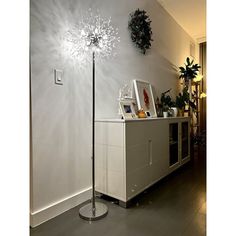 the floor lamp is next to a white cabinet