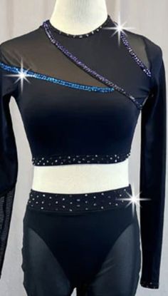 a female mannequin wearing a black and white outfit with blue sequins