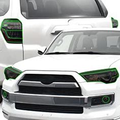 two white trucks with green trims on them