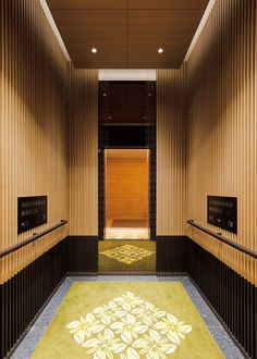 an elevator with decorative flooring and wooden walls