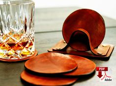 a set of coasters and a glass on a table