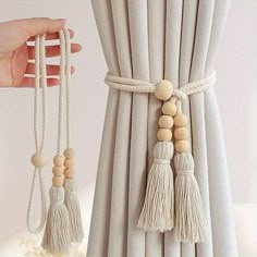 the curtains are made from wood beads and tasseled with white thread, which is attached to a curtain rod