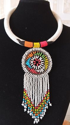 White Zulu African Beaded Necklace, African Jewelry,Tribal Necklace, Boho Necklace, Women Jewelry, Pendant Necklace, Gift For HerThis elegant statement necklace is made of Zulu fine Beads.Main Color - White.Available in different colors.For any clarification ...please send an e-mail or convo..Thank you for visiting... Unique White Round Pendant Necklace, White Bohemian Jewelry With Large Beads, Artisan White Round Necklaces, Artisan White Round Necklace, Traditional White Adjustable Choker, Artisan White Handmade Necklaces, Artisan Handmade White Necklaces, White Round Pendant Necklace For Festival, White Handmade Artisan Necklace