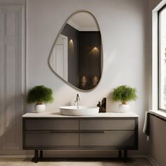 a bathroom with two sinks and a large mirror on the wall above it's counter