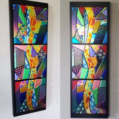 two colorful stained glass panels hanging on the wall