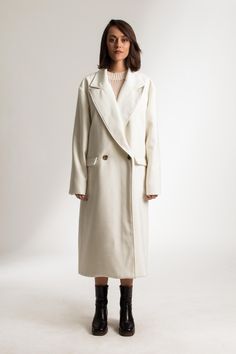 The Jenny Coat is a relaxed fit, double-breasted coat. Crafted from a virgin wool blend, which creates a structured, tailored look and feel. This full-length coat has oversized lapels and features two flap pockets. ITEM DETAILS:  -- Oversized Fit - Double Breasted - Dropped Shoulders - Fully Lined - Front flap pockets The model is 173cm high and wears size EU36/US4/UK8 CUSTOM MADE ORDERS also available, just make sure you enter your measurements details in the notes section, so we can tailor make this babe just for ya. PLEASE ALLOW 1-3 BUSINESS DAYS FOR PRODUCTION FABRIC: Wool Blend White Double-breasted Pea Coat For Winter, Cream Double-breasted Long Sleeve Outerwear, Cream Long Sleeve Outerwear With Double-breasted Fastening, Cream Long Sleeve Double-breasted Outerwear, White Wool Outerwear For Office, Cream Pea Coat With Double Button Closure For Work, White Wool Outerwear With Notch Lapel, Classic Long Wool Coat In Winter White, Classic Winter White Long Wool Coat