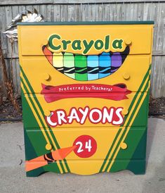 a crayon box with the words crayons painted on it's sides