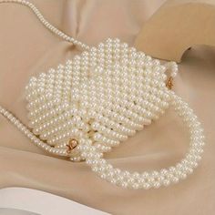 Why You'll Love It: Add a luxurious element to your style with this versatile faux pearl bag. The handmade craftsmanship guarantees a unique, high-quality accessory that is perfect for adding elegance to your everyday looks or standing out at special occasions. Key Features: *Material: High-quality faux pearls woven into a durable, elegant structure. *Versatile Style: Great for everyday use, weddings, parties, or adding a touch of elegance to any occasion. *Compact Size: Fits your essentials comfortably -- Dimensions: Height 19cm (7.48 inches), Length 15cm (5.91 inches), Width 7.5cm (2.95 inches). *Functional Design: Comes with a convenient handle and a long shoulder strap, giving you the option to carry it as a handbag or wear it as a crossbody. *Color: Available in a delicate pearl white Elegant Cream Bags, Elegant Crossbody Evening Bag With Pearl Handle, Elegant Pearl Handle Crossbody Evening Bag, Elegant Cream Bag, Cream Bags With Pearl Handle, Fashion Cream Bag With Pearl Handle, Crossbody Bag With Pearl Handle For Gift, Crossbody Bag With Pearl Handle Perfect For Gifts, Pearl Handle Crossbody Bag For Gift