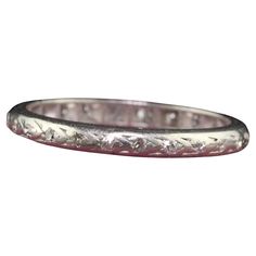 Beautiful Antique Art Deco Platinum Single Cut Diamond Engraved Eternity Band - Size 5 1/2. This beautiful wedding band is crafted in platinum. The ring has deep set single cut diamonds that go around the entire ring. The ring is in fair condition with no structural issues and sits low on the finger. Item #R1655 Metal: Platinum Weight: 2.3 Grams Size: 5 1/2 Diamonds: Approximately .15 cts Color: H - I Clarity: VS2 - SI1 Measurements: Top of the ring measures 2.25 mm wide and band measures 2.25 mm wide. Measurements off the finger: 1.43 mm high Layaway: For your convenience, we will be happy to provide layaway payment options. Please contact us to work out a layaway plan which best suits your needs. All layaway purchases are final sale. All domestic and international shipments are shipped w Elegant Etched Bands For Anniversary, Ceremonial Wedding Rings With Decorative Band, Classic Silver Platinum Eternity Band, Classic Platinum Silver Eternity Band, Classic Platinum Eternity Band, Wedding Platinum Eternity Band With Diamond Cut, Wedding Eternity Band With Diamond Cut In Platinum, White Gold Decorative Eternity Band For Wedding, Luxury Silver Engraved Bands