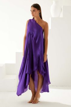 Purple one shoulder high-low dress featuring pleated draped design, Fit: Relaxed Pre-draped Asymmetrical Sleeveless Ruched Dress, Pre-draped Ruched Asymmetrical Sleeveless Dress, Pre-draped Asymmetrical Sleeveless Dress, Sleeveless Ruched Asymmetrical Dress, Pre-draped Sleeveless Summer Midi Dress, Summer Pleated Pre-draped Maxi Dress, Pre-draped Midi Dress With Asymmetrical Hem For Summer, Pre-draped Sleeveless One Shoulder Cocktail Dress, Pleated Asymmetrical One Shoulder Summer Dress