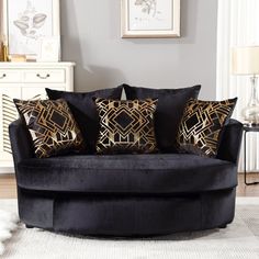 a black couch with gold pillows in a living room