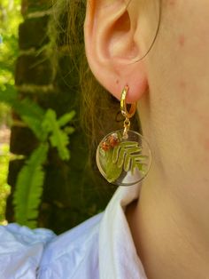 Add a touch of enchantment to your fall wardrobe with these stunning gold-filled dangle earrings made of resin, featuring real acorn, fern, and oak leaf accents. These unique pieces are the perfect accessory for the autumn season, making them an ideal gift for Thanksgiving or as a thoughtful hostess gift. Embrace your inner forest witch with these Mori Kei inspired forest jewelry pieces, which are also a wonderful gift for a teacher, daughter, friend, or girlfriend. Bring a little piece of the f Nature-inspired Drop Earrings With Birth Flower, Nature-inspired Birth Flower Drop Earrings, Botanical Style Gold Resin Jewelry, Nature-inspired Dangle Hoop Earrings For Gift, Nature-inspired Dangle Hoop Earrings, Nature-inspired Dangle Hoop Earrings As Gift, Gold Nature-inspired Hoop Earrings, Nature-inspired Gold Hoop Earrings, Nature-inspired Dangle Flower Earrings