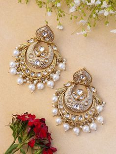 Unleash your inner diva with our mesmerizing Indian Kundan and polki Earrings. Designed to make a bold statement, these earrings exude captivating splendor, blending traditional Indian aesthetics with contemporary allure. Crafted with meticulous attention to detail, these earrings showcase the artistry of Kundan work. The vibrant Kundan stones take center stage, radiating a luminous charm that catches every eye. The intricate setting in gleaming golden tones adds an element of opulence and eleva Luxury Kundan Chandbalis In Fusion Style, Luxury Kundan Chandbali Pearl Earrings, Luxury Kundan Bridal Earrings For Diwali, Luxury Fusion Style Pearl Earrings With Meenakari, Luxury Gold Kundan Chandelier Earrings, Luxury Kundan Chandelier Earrings For Reception, Luxury Meenakari Chandelier Earrings For Diwali, Luxury Kundan Chandbali Danglers, Luxury Kundan Chandelier Earrings For Wedding