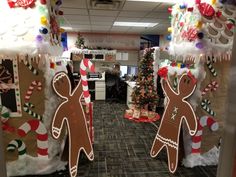 an office decorated for christmas with gingerbread man and woman