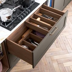 an open drawer in the middle of a kitchen counter