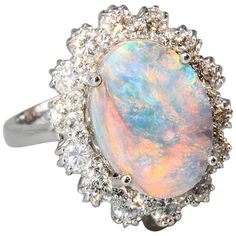 Chic black opal, diamond and 18K white gold dome ring. It features a large oval shaped approx. 4.50 carat black opal as the focal point and flanked by approx. 1.00 carats of high grade round brilliant cut diamonds, all set in 18K white gold. Currently size 6.5, but can be sized slightly up or down. Hallmarks: 18K. Opal Ring Vintage, Blue Opal Ring, Black Opal Ring, Baguette Diamond Rings, Opal Ring Gold, Engagement Rings Opal, Steampunk Jewelry, 18k Gold Ring, Rose Gold Engagement