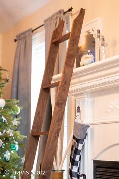 a wooden ladder leaning up against a christmas tree