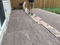 a man standing on top of a wooden deck