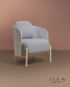 a white chair sitting on top of a brown floor next to a pink and beige wall