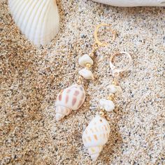 Capture the essence of sun-soaked shores and ocean breezes with our Paia Seashell earrings. The seashell exudes natural elegance with the complements of other shells and golden beads, adding a touch of sophistication. Elevate your style with these beach-inspired earrings that effortlessly blend coastal charm and timeless beauty. Whether you're strolling along the shore or attending a special occasion, let these earrings be a symbol of your love for the sea and your appreciation for refined, coastal-inspired fashion. Real seashells with golden beads Trendy huggie earring design Size: 1/2" W x 1.5" L Jewelry pouch included (color may differ) In interests of hygiene and for your protection, we cannot accept returns on earrings. Ocean-inspired Beach Earrings With Ear Wire, Coastal Style Beach Earrings For Summer, Summer Beach Dangle Jewelry, Gold Shell For Beach Season, Elegant Shell Necklace For Summer Beach, Elegant Shell Necklace For Summer Beach Occasions, Beach Shell Jewelry With Ear Wire, Bohemian Beach Shell Earrings For Pierced Ears, Bohemian Beach Shell Earrings