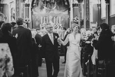 a bride and groom walking down the aisle