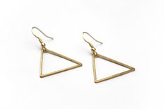 "Lightweight, geometric triangle earrings perfect for your next day out in the summer sunshine. ▲ Brass triangles measure approx. 1 1/4\" ▲ Gold-plated surgical steel earring hooks (hypoallergenic) We try to display product colors as close to life as possible. However, all monitors are different and so there might be slight color variations from screen to screen. CARE INSTRUCTIONS Jewelry should be kept away from moisture as much as possible. Remember to take your jewelry off before swimming and Minimalist Metal Earrings For Summer, Minimalist Earrings For Summer, Minimalist Triangle Earrings For Everyday, Minimalist Summer Earrings, Handmade Minimalist Triangle Earrings, Minimalist Summer Earrings With Ear Wire, Minimalist Handmade Triangle Earrings, Everyday Summer Brass Earrings, Adjustable Minimalist Earrings For Summer