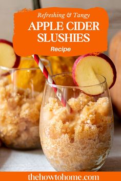 two glasses filled with apple cider slushies on top of a table next to apples