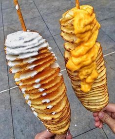 there are two cones with different types of food on them, one is covered in cheese and the other has ice cream