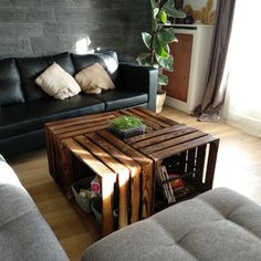 a living room with two couches and a coffee table made out of wooden pallets