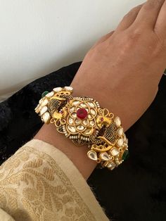 New arrivals for the festival season ♥️ The gorgeous Kada is beautifully handcrafted by our skilled Indian craftsmen in Kundan stones, beads, multi-colored stones, mini pearls, and gold plated. Material: Brass with gold plating This is one of a kind designer piece that will make you stand out among the crowd Easily Openable with a screw  For wrist size 2.4 to 2.6 Festive Fusion Bracelets With Intricate Design, Temple Jewelry Bracelet With Peacock Design For Festivals, Bohemian Kundan Bracelets For Festivals, Peacock Design Bracelets For Festivals And Gifts, Diwali Temple Jewelry Bracelets With Stone Work, Temple Jewelry Bracelets With Stone Work For Celebrations, Ceremonial Temple Jewelry Bracelets With Peacock Design, Temple Jewelry Bracelets For Celebration With Stone Work, Fusion Style Bracelet For Diwali Festivities