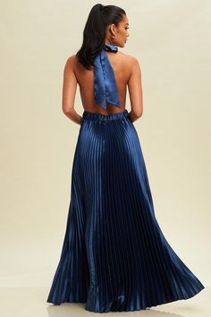 The Bella Maxi dress is a stylish and elegant piece, featuring a navy satin pleated halter design. The luxurious fabric drapes beautifully and the halter neckline adds a touch of sophistication. Perfect for formal occasions, this dress will make you feel confident and chic.